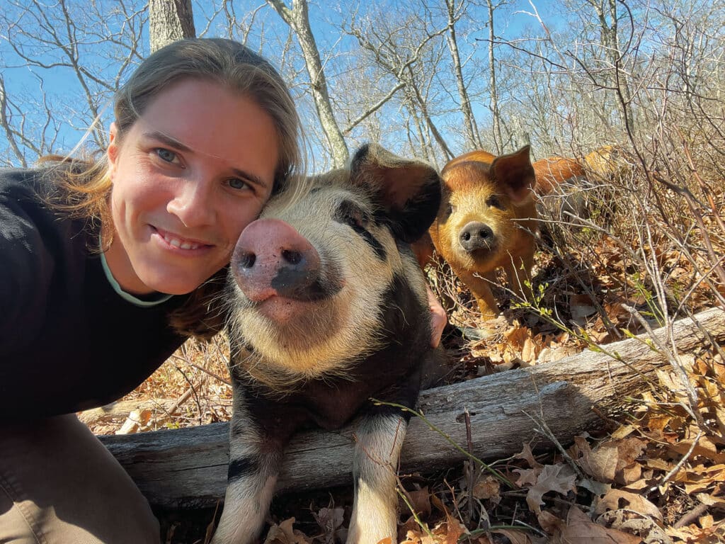 Jo Douglas '06 with some of the pigs she raises at Farm to Fork