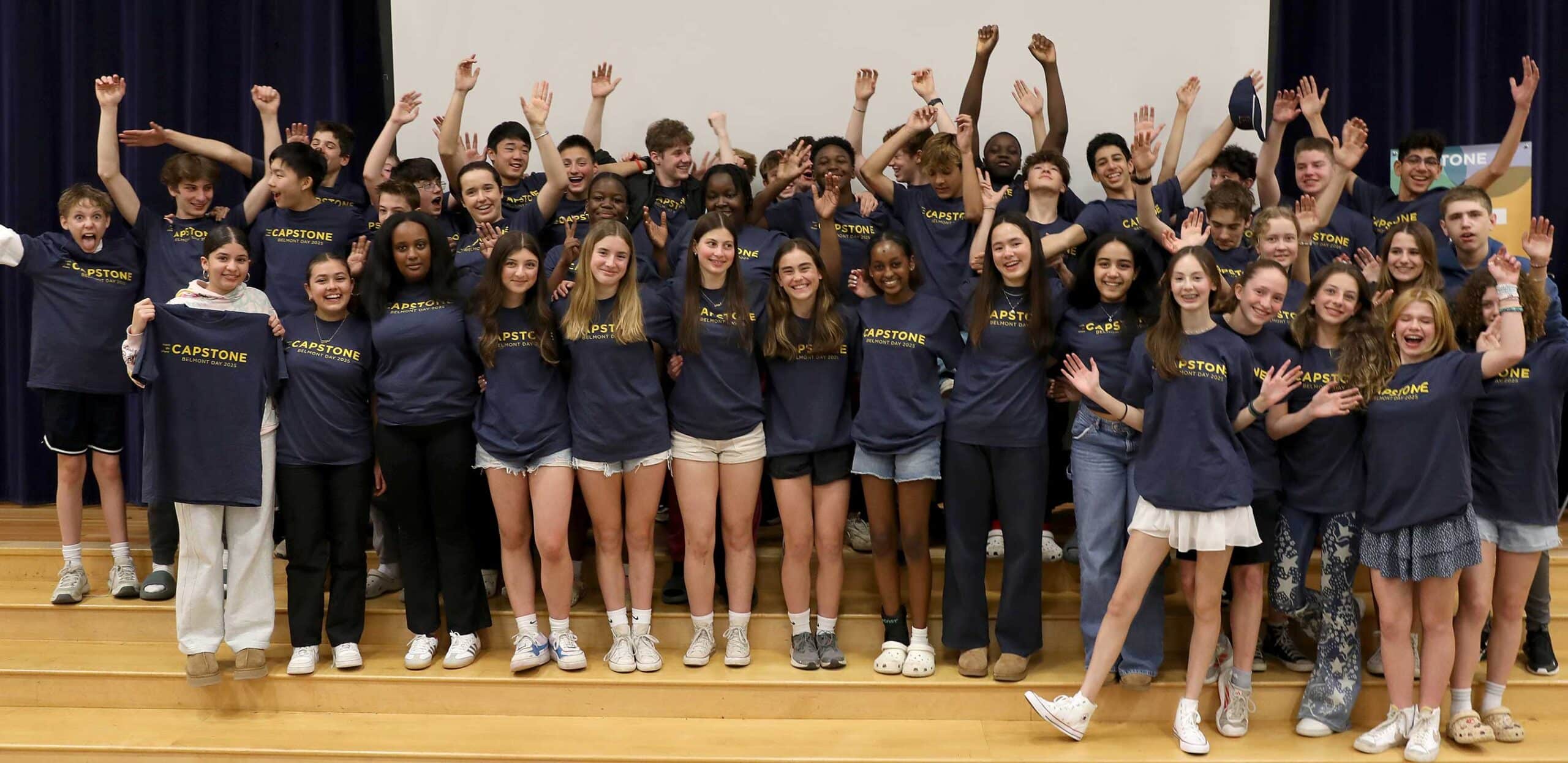 The eighth grade class wearing their Capstone shirts